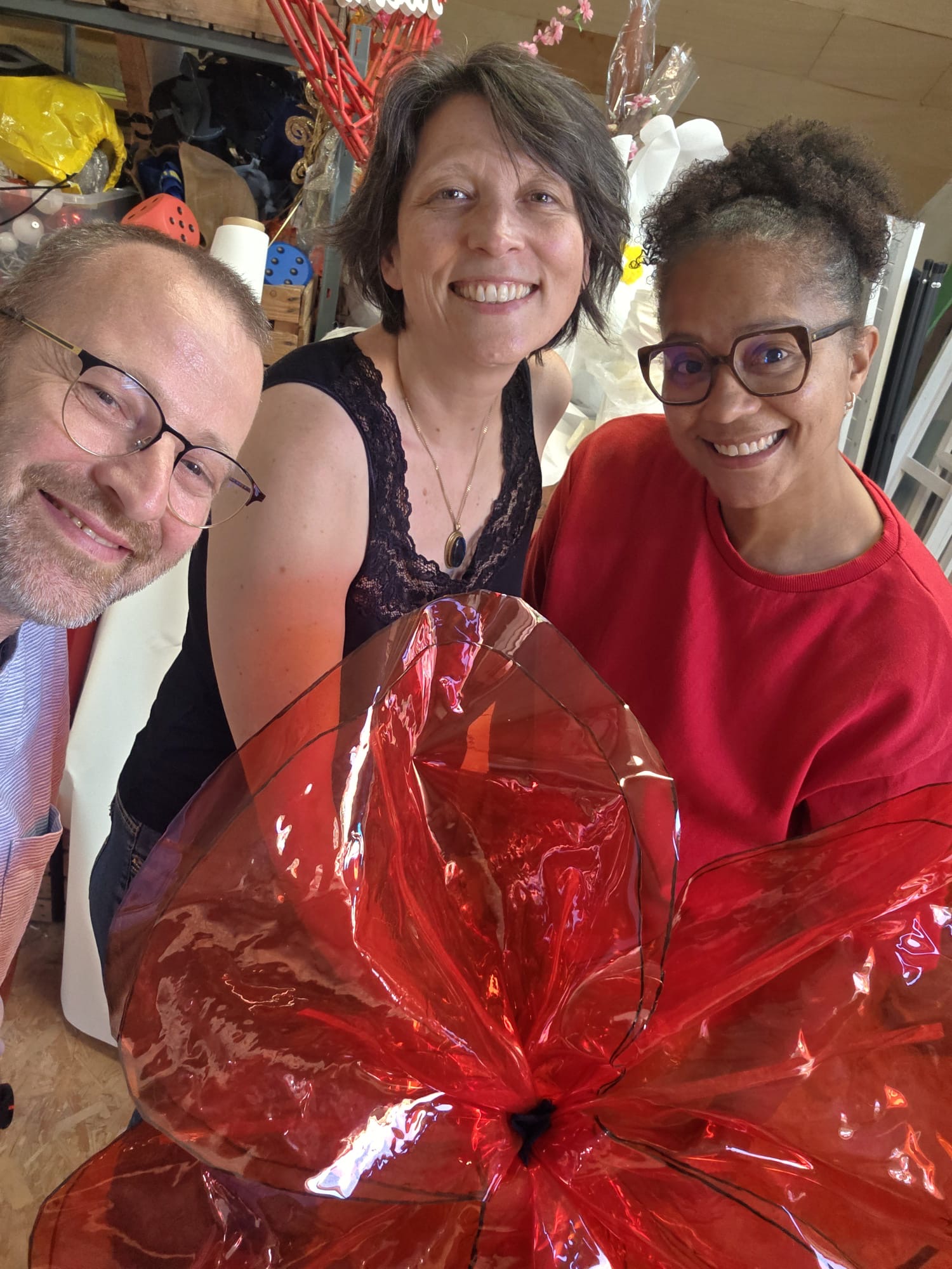 Julien et Carole de JUCA présentant un coquelicot géant réalisé pour le spectacle olfactif CocQuiKolis.